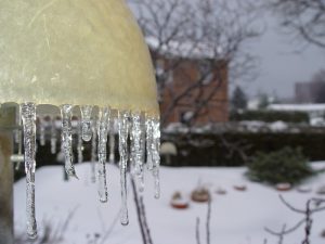 Photo shows icicles hanging from a  street lamp