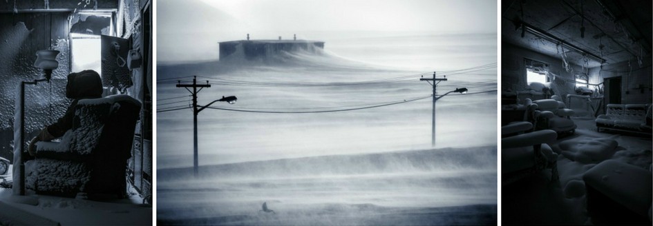 Three black and white images by aAron munson of the abandoned Isachsen weather station. The first shows a man in a parka, with the hood up, sitting in an armchair in a snow filled room. The second shows a windswept snowy landscape, with building in the distance and electricity poles in the foreground. The third shows an empty frozen sitting room, the furniture covered in snow.