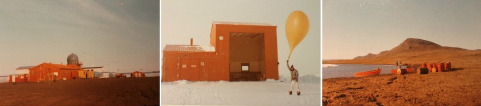 Three colour photographs of Isachsen weather station in the years 1974-75. The first shows the station, a collection of brown buildings, in the full sunshine. The second shows a man holding a large yellow weather balloon, with a building in the rear. The third shows a beach, with a rowboat pulled up to the shore, and a collection of empty barrels lying beside it.