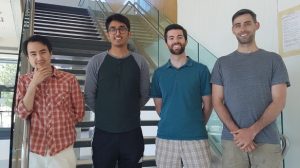 Photograph showing four young men, smiling, wearing summer clothes. They are part of the Moore group and authors of The Lunar Atmosphere