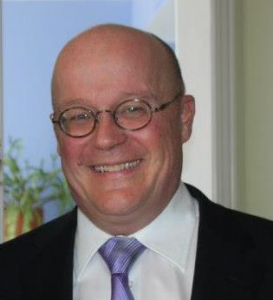 Michael Crowe, author of ArcRCC article, a middle aged bald man with glasses, smiling.