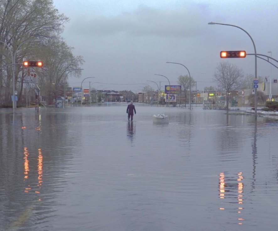 Photo of a man walking down a deserted flooded street in Montreal for the article by Bronwyn McIlroy-Young on weathercasters as climate change communicators