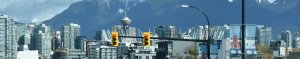 Vancouver skyline showing the tower and traffic lights with mountains in the background